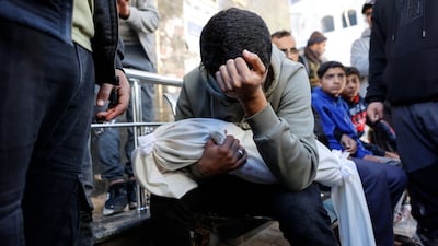 A Palestinian carries the body of Ahmed Al Nader, his five-month-old brother, who was reported to have been killed on Friday along with relatives by Israeli shelling in the Tuffah neighbourhood of Gaza city. AFP