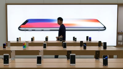 A person walks past the Apple iPhone X display in Taipei, Taiwan. EPA