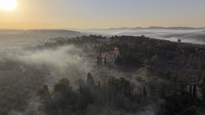 A drone view shows smoke rising near Latrun Monastery, after wildfires broke out due to extreme heat and winds, in central Israel. Reuters