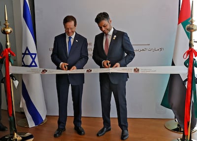 Israeli President Isaac Herzog, left, and Emirati Ambassador to Israel Mohamed AL Khaja cut the ribbon at the new UAE embassy in Tel Aviv. AFP