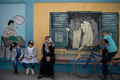 Two Palestinian girls, left, sit outside an UNRWA school before attending first day of class in Gaza City, Wednesday, Aug. 29, 2018. AP Photo