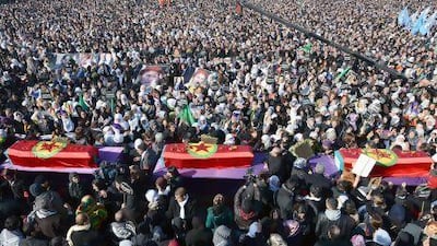 The coffins of three Kurdish activists are carried through a crowd of tens of thousands of people at their funeral in Diyarbakir, sourtheastern Turkey.