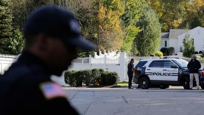 Police officers stand in front of property owned by former Secretary of State Hillary Clinton and former President Bill Clinton in Chappaqua, New York. A US official says a "functional explosive device" was found at the Clinton's suburban New York home. AP