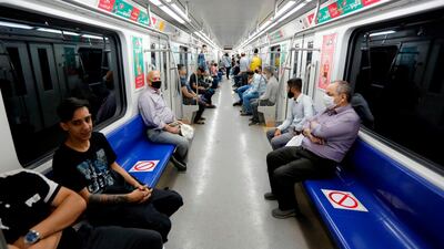 Iranians, mostly wearing face masks, sit in a train carriage at a metro station in the capital Tehran amid the coronavirus crisis. AFP