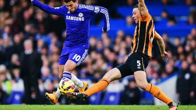 Eden Hazard, left, of Chelsea evades the challenge by James Chester of Hull City during their English Premier League match at Stamford Bridge on December 13, 2014, in London, England. Jamie McDonald / Getty Images