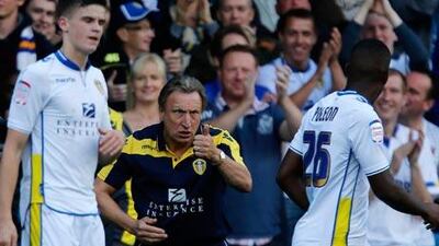Neil Warnock, the manager of Leeds United, directs his team on the field.