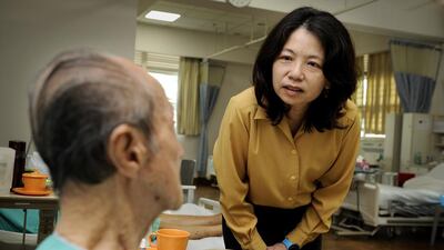 Loh Shu Ching, chief executive of the Ren Ci Hospital, chatting with a patient in a ward. Singapore’s healthcare system has won global accolades including from the World Health Organisation, Bloomberg and the Economist Intelligence Unit.