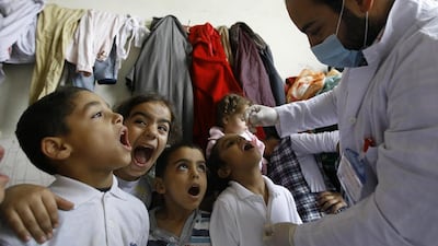 Syrian refugee children line up to receive vaccinations against polio at a camp in Lebanon. Mohammed Zaatari / AP