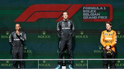 Race winner George Russell on the podium with Lewis Hamilton and Oscar Piastri. AP