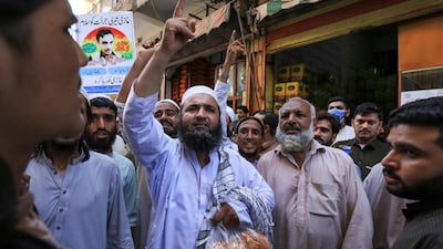 Men in Peshawar, Pakistan, chant slogans in favour of a teenager facing murder charges over the killing in court of a US citizen accused of blasphemy. Reuters