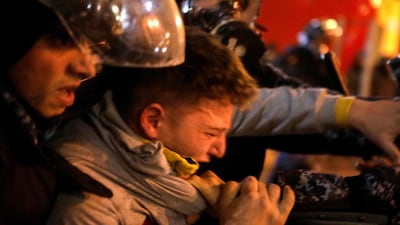 Riot police detain an anti-government protester. AFP