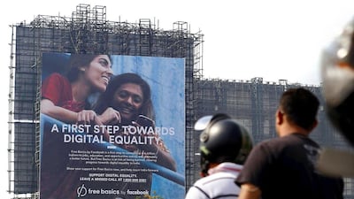 Motorists ride past a billboard displaying Facebook's Free Basics initiative in Mumbai. Danish Siddiqui / Reuters