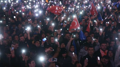 Supporters of Turkey's ruling AKP cheer as they follow the election's results in front of the party's headquarters in Ankara on March 30. Adem Altan/ AFP Photo