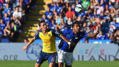Mesut Ozil of Arsenal is challenged by Liam Moore of Leicester City during their Premier League match on Sunday. Michael Regan / Getty Images
