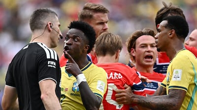 Brazil winger Vinicius Junior remonstrates with assistant referee Corey Parker. Reuters