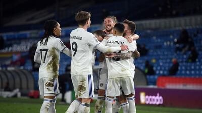Leeds United's Stuart Dallas celebrates scoring their side's second goal of the game with team-mates during the Premier League match at Elland Road, Leeds. Picture date: Tuesday February 23, 2021. PA Photo. See PA story SOCCER Leeds. Photo credit should read: Gareth Copley/PA Wire. RESTRICTIONS: EDITORIAL USE ONLY No use with unauthorised audio, video, data, fixture lists, club/league logos or "live" services. Online in-match use limited to 120 images, no video emulation. No use in betting, games or single club/league/player publications.
