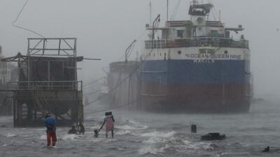 Filipino children wade through rising seawater at a fish port in Navotas city, east of Manila, Philippines. Francis R. Malasig / EPA