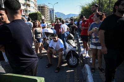 People wait for news of their loved ones outside the port in Kyrenia, northern Cyprus. AFP