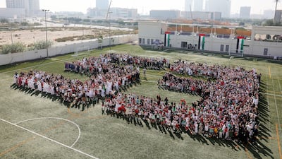 More than 1,500 pupils and teachers of Repton Al Barsha in Dubai assembled on their campus grounds to form the number 53 to mark Eid Al Etihad celebrations. Pawan Singh / The National