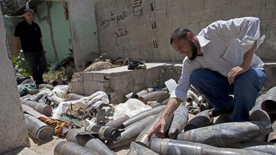 Murad, perhaps Gaza’s foremost expert at disarming unexploded Israeli artillery shells, examines a collection of Israeli tank shells and other munitions that have been collected and brought to a police station located by an UN school in Nussarat central Gaza. Some of them have been diffused but some not. Murad was later killed days later while trying to defuse an unexploded Israeli missile. Five others were also killed including Italian video journalist Simone Camilli and his Palestinian translator. AP Palestinian photographer from Gaza Hatem Moussa was wounded in the incident.