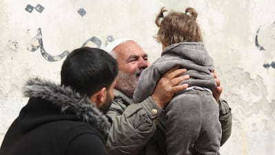 Ibrahim Othman plays with the little girl he found abandoned on the doorstep of the village mosque and called Hibatullah. AFP