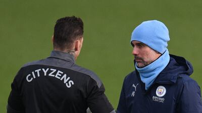Manchester City goalkeeper Ederson speaks with manager Pep Guardiola. AFP