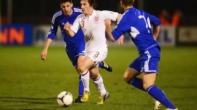 Leighton Baines, centre, of England takes on the San Marino defence during a World Cup qualifier on Friday in Serravalle, San Marino. England rolled to a 8-0 win. Mike Hewitt / Getty Images
