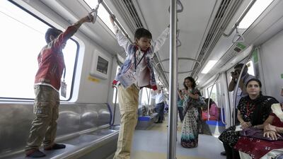 Children enjoy the ride during the opening of the Mumbai metro line, which has missed deadlines because of lack of right of way, changes in design and lack of approvals from the railways. Divyakant Solanki / EPA