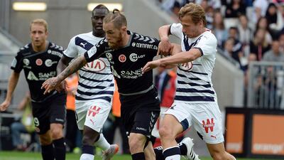 Bordeaux midfielder Clement Chantome, right, challenges Reims midfielder Antoine Devaux. Jean Pierre Muller / AFP