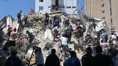 People search for survivors amid the rubble of a collapsed building after a deadly earthquake in Cali, Colombia. AFP