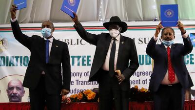Sudan's Sovereign Council Chief General Abdel Fattah Al Burhan, South Sudan's President Salva Kiir, and Sudan's Prime Minister Abdalla Hamdok raise copies of a signed peace agreement with Sudan's five key rebel groups in Juba, South Sudan on August 31, 2020. Reuters