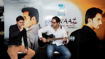 Aejaz Ahmed, left, came to work in Abu Dhabi last year as a deliveryman and is now singing on the Zee TV show Parwaaz. Courtesy Zee TV Middle East