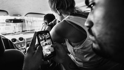 In this image released by World Press Photo titled “Citizen Journalism in Brazil’s Favelas” by photographer Sebastian Liste for Noor agency which won third prize in the Daily Life Stories category shows the leader of the Papo Reto collective receiving an image of a 22-year-old taxi driver who was shot dead by a police officer, Rio de Janeiro, Brazil, Feb. 8, 2015. A group of friends from Alemao, a slum in Rio de Janeiro, formed a media collective called Papo Reto, or “straight talk”. Social media allow them to report stories from their community otherwise ignored by traditional media. Sebastian Liste / Noor, World Press Photo via AP