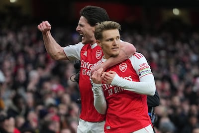 Arsenal's Martin Odegaard, right, celebrates with Declan Rice after scoring against Brighton and Hove Albion. AP