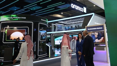 Delegates stop to talk in front of the Aramco booth at the WPC Energy Congress in Riyadh. AFP