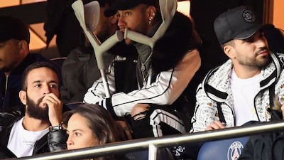 Accompanied by crutches for his broken foot, Neymar, centre, watches PSG take on Bordeaux on Saturday. AFP