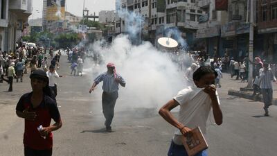 Anti-government protesters demanding the ousting of Yemen's President Ali Abdullah Saleh flee after security forces fired tear gas grenades at them during clashes in the southern city of Taiz on September 19, 2011. Stringer / Reuters