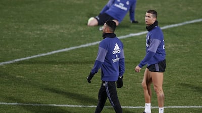 Cristiano Ronaldo and his Real Madrid teammates warm up during a training session in Yokohama near Tokyo on Monday, December 12, 2016. Cristiano Ronaldo takes a rest after warming up. Yuya Shino / EPA