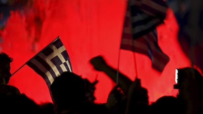 No supporters wave Greek national flags on the main Constitution square in Athens. Yannis Behrakis / Reuters