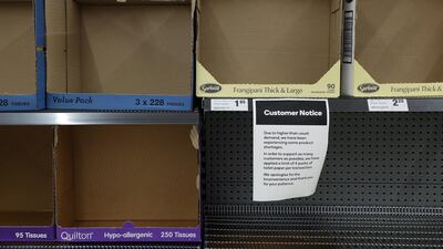 A notice indicating a shortage of supplies is displayed on empty tissue paper shelves at a supermarket in Sydney, Australia. Bloomberg