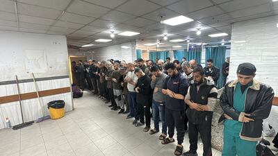 People pray for Palestinians killed at Kamal Adwan Hospital. Reuters