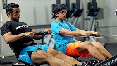 Emirati Hamad Al Sabri, 15, was tired of fat jokes at school and of being barred from races because of fears for his health. He has lost 11kg in the ‘Intisaar’ initiative. With him is Mohammed Kassim, 30, Intisaar’s ambassador, at Inner Fight gym in Dubai. Satish Kumar / The National