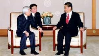 The Chinese vice president Xi Jinping (right) talks with the Japanese Emperor Akihito at the Imperial Palace in Tokyo.