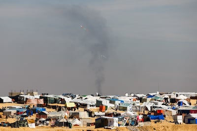 Smoke from Israeli strikes rises behind a camp for displaced Gazans in Rafah. Reuters
