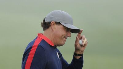 USA’s Phil Mickelson tips his hat after making a putt on the first hole during morning foursomes at the Ryder Cup. Charlie Riedel / AP Photo
