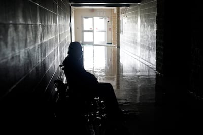 A man waits in a wheelchair in a hurricane shelter. Rick Wilking/ Reuters.
