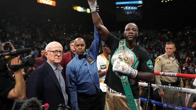 WBC heavyweight champion Deontay Wilder poses with referee Kenny Bayless after defeating Luis Ortiz. AFP