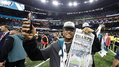 Philadelphia Eagles family member holds up a copy of the Philadelpnia Enquirer newspaper. EPA