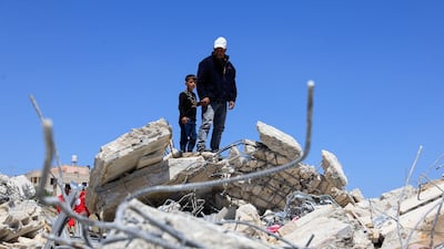 Palestinians inspect the rubble of a building destroyed by Israel near Hebron, in the occupied West Bank. Reuters