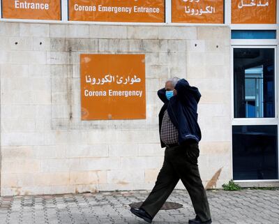 A man wears a face mask as he walks near the entrance of emergency at Rafik Hariri hospital, as Lebanon recorded its first death from coronavirus, in Beirut, Lebanon March 10, 2020. REUTERS/Mohamed Azakir